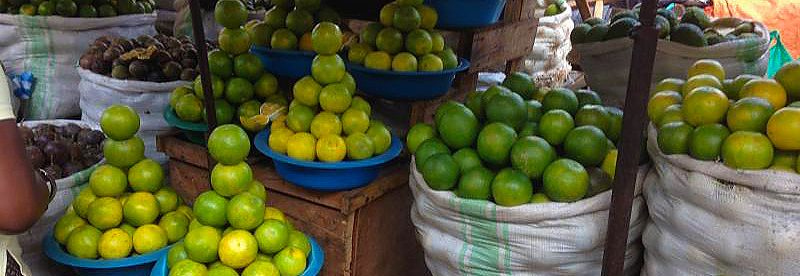 Stacked citrus at a stall in Nakawa Market, Kampala, Uganda