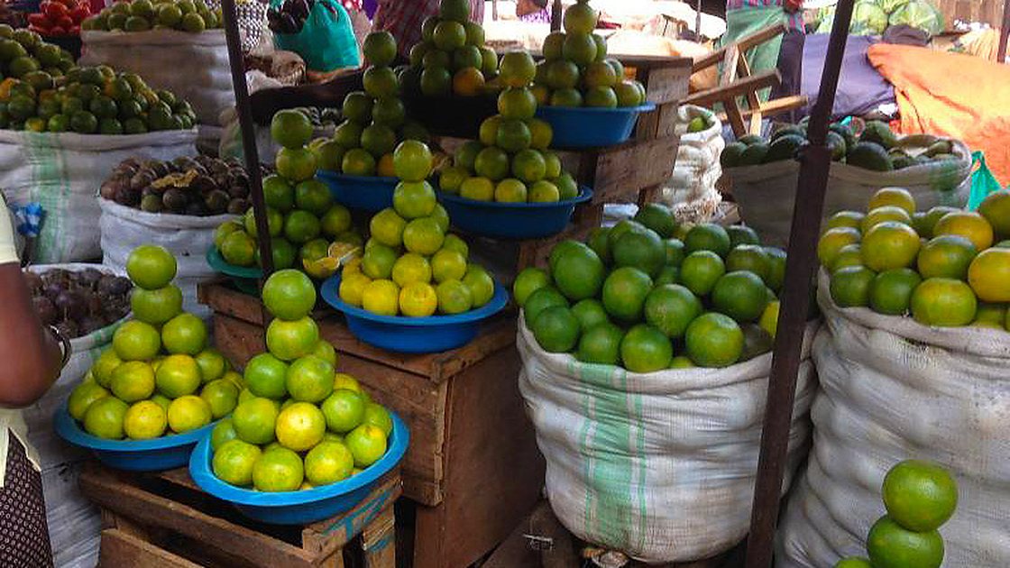 Stacked citrus at a stall in Nakawa Market, Kampala, Uganda