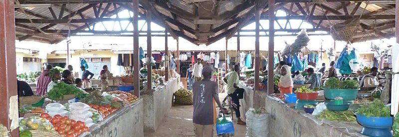 Covered aisle of produce stalls at Kabale Main Market, Uganda