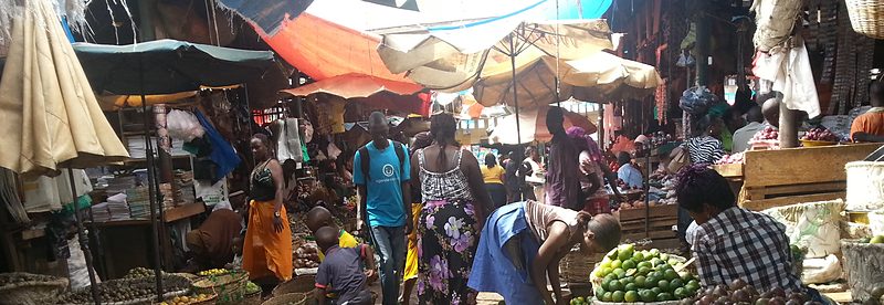 Covered produce stalls along an aisle at Kiboga Main Market, Uganda