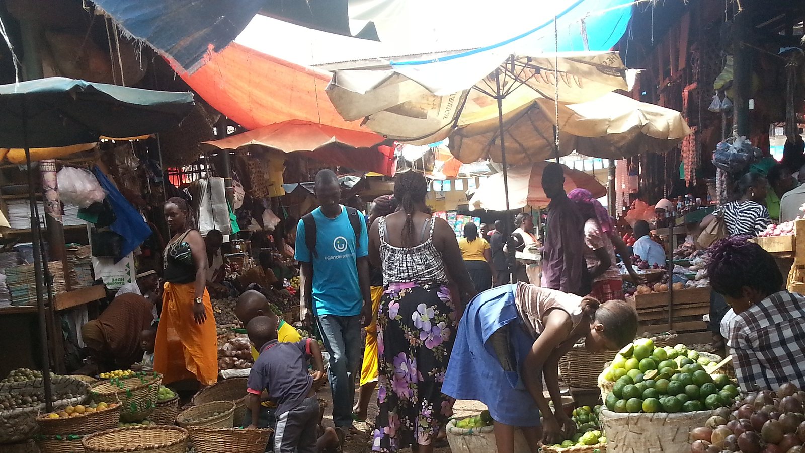 Covered produce stalls along an aisle at Kiboga Main Market, Uganda