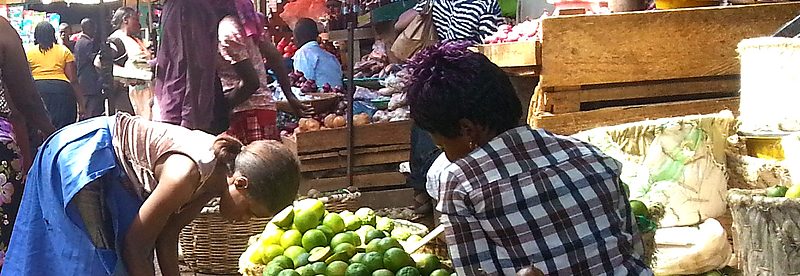 Covered produce stalls with tomatoes at Kalerwe Market, Kampala, Uganda